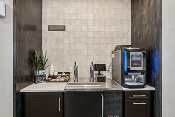 A bathroom with a toilet, sink, and a computer